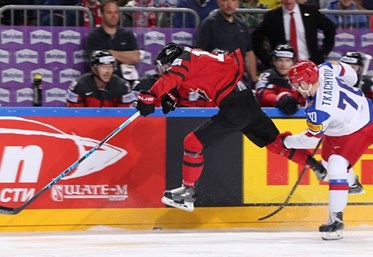 COLOGNE, GERMANY - MAY 20: Canada's Mitch Marner #16 slips by Russia's Vladimir Tkachyov #70 during semifinal round action at the 2017 IIHF Ice Hockey World Championship. (Photo by Andre Ringuette/HHOF-IIHF Images)

